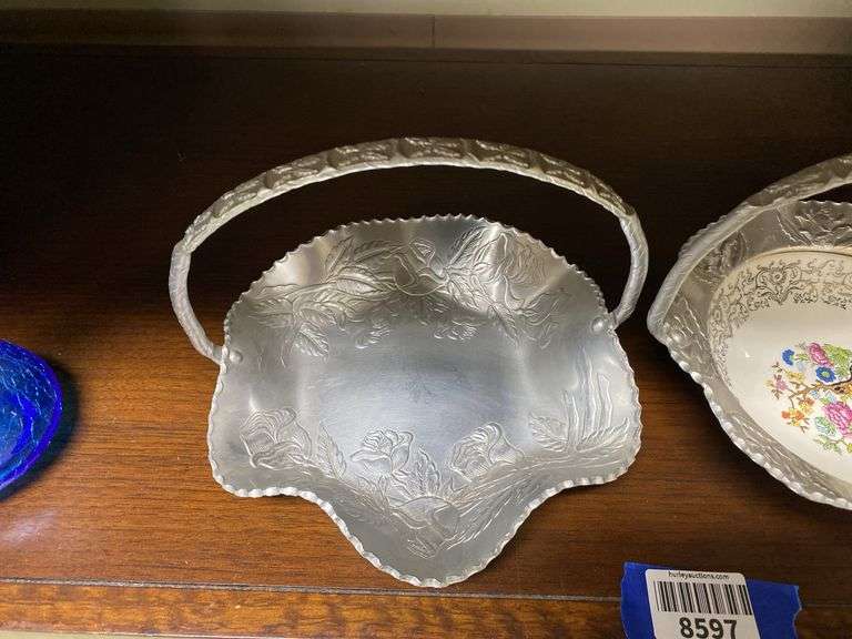 Two hammered aluminum baskets, one has china dish center