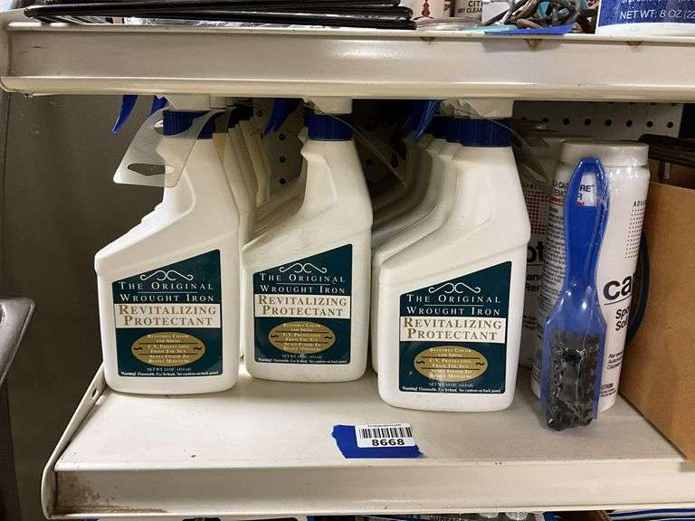 Contents of shelf: wrought iron protector, carpet cleaner, misc