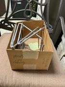 Contents of shelf: wrought iron protector, carpet cleaner, misc