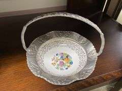 Two hammered aluminum baskets, one has china dish center