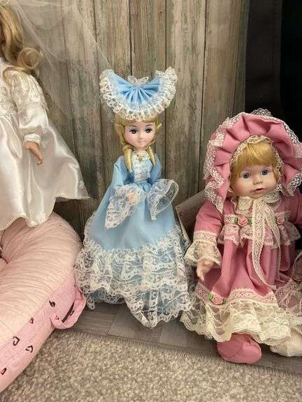 Four porcelain collector dolls