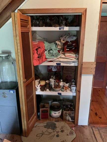Contents of closet: nodder dog, animal figurines, Mercersburg t-shirts, linens, slow cooker, kitchenware, misc