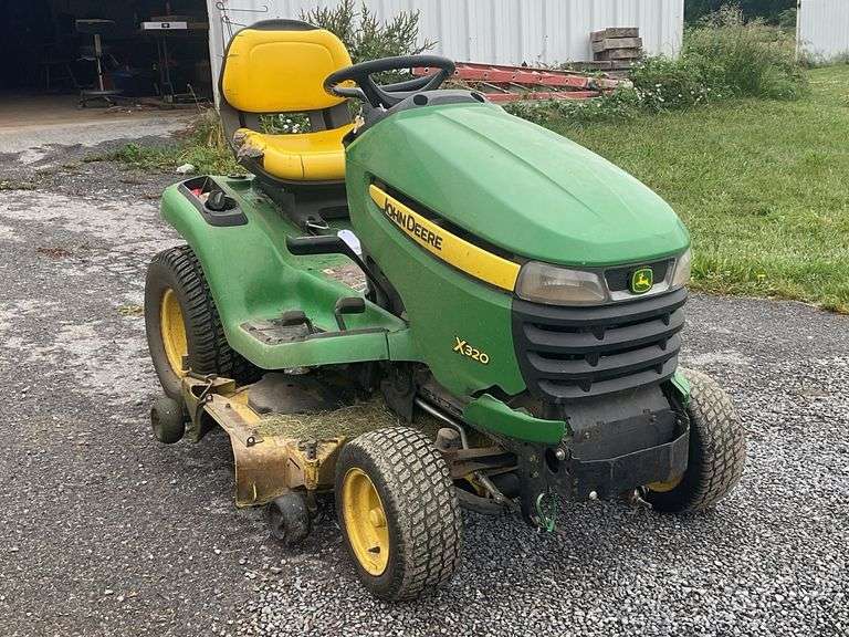 John Deere X320 48” riding mower with 1053.0 hours on meter. Hours subject to change as it’s still being used to mow property, one blade needs reattached.