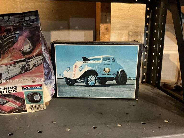 Contents of shelf: vintage car/truck model kits in boxes
