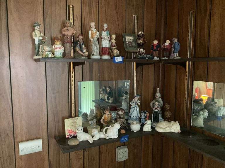 Contents of two shelves: people and animal figurines, decor items