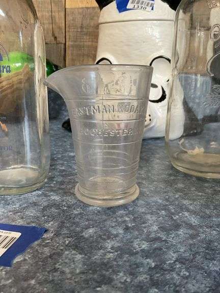 Eastman-Kodak graduated measure and vintage bottles
