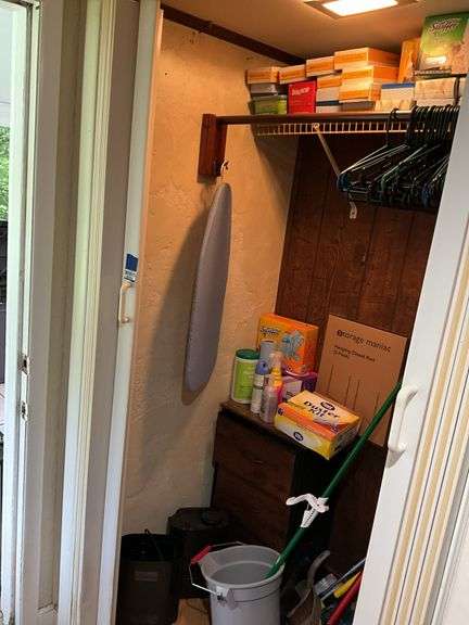 Contents of closet: MooSoo vacuum, Hoover upright vacuum, hand vac, cleaning supplies, Swiffer and refills, drawer unit, metal shelf unit, hangers, misc