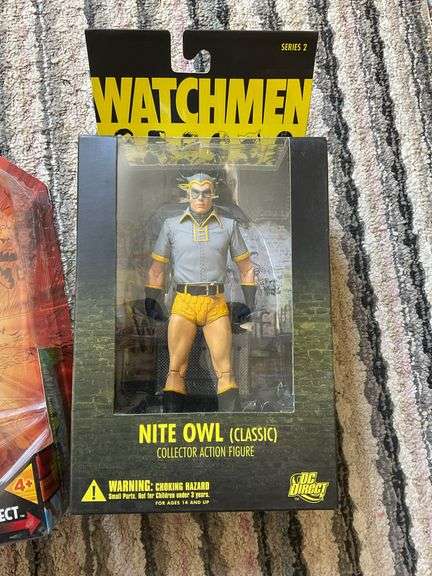 Two action figures in packages: Power Girl and Nite Owl