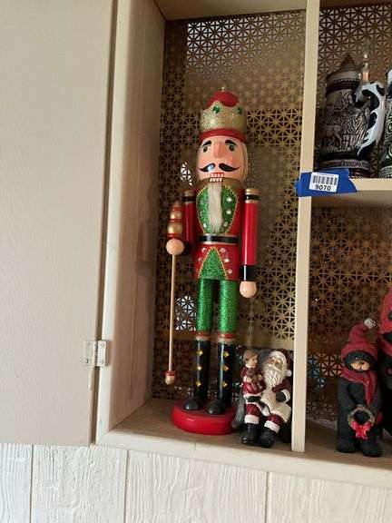 Contents of cupboard: nutcracker, Christmas figurines and decor, beer steins