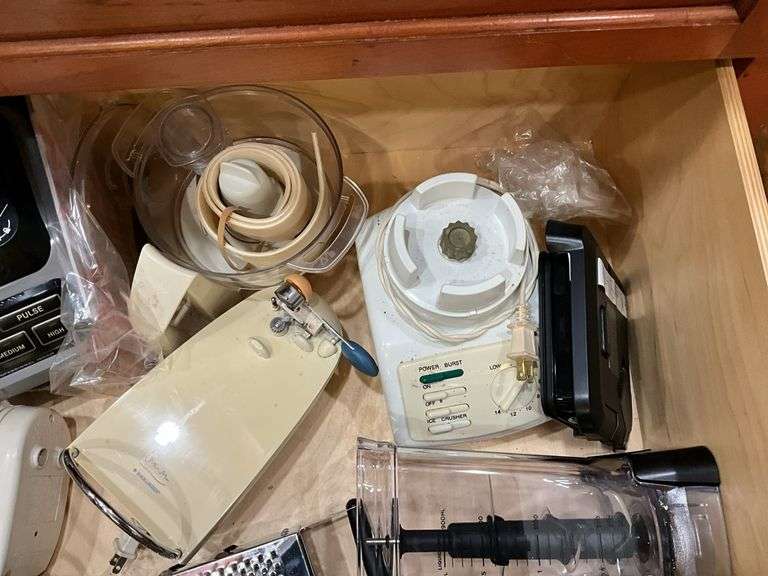 Contents of drawer: blenders, electric knife, hand mixer, grater