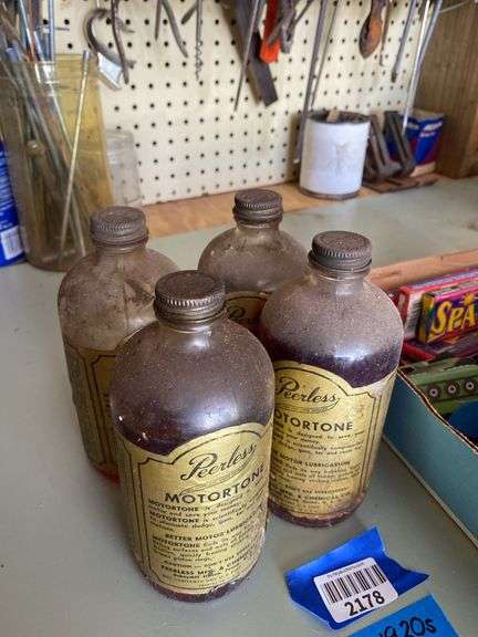 Four Peerless Motortone bottles w/ paper labels