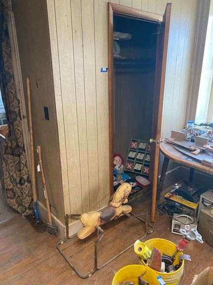 Vintage riding horse and contents of closet: baby scale, toy rifles, child's turntable, Raggedy Ann & Andy dolls, toy cars, misc toys