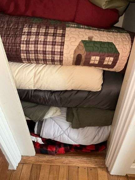 Contents of closet: drapery panels, hangers, throw pillows, comforters