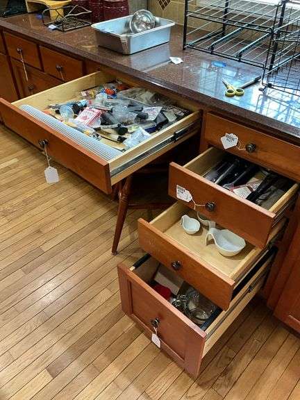 Contents of four drawers: gadgets, household items, measuring cups, power strip, misc