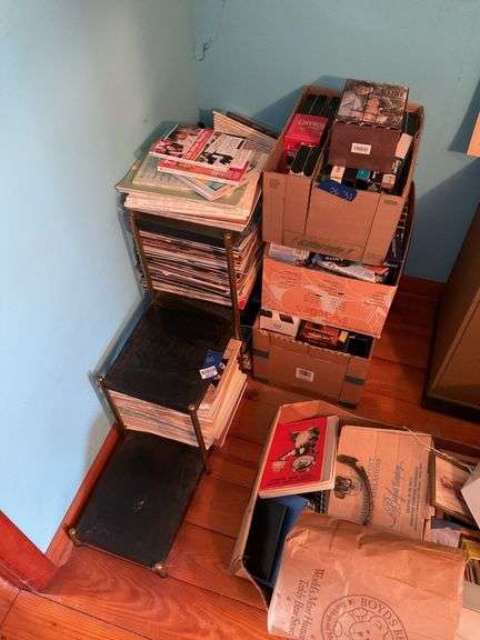 Corner lot: shelf unit and contents: TV Guides, clock magazines, Chilton's car manuals, DVDs, VHS tapes