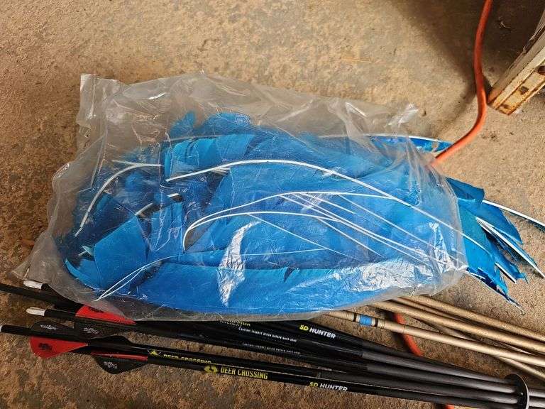Contents of shelf: archery arrows and supplies