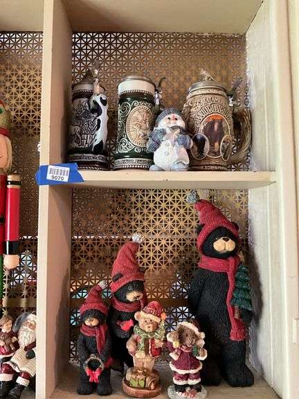 Contents of cupboard: nutcracker, Christmas figurines and decor, beer steins
