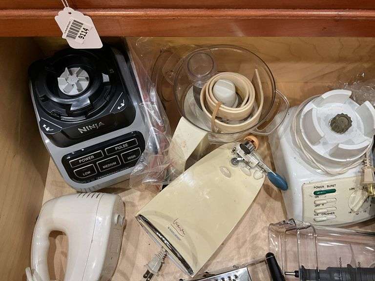 Contents of drawer: blenders, electric knife, hand mixer, grater
