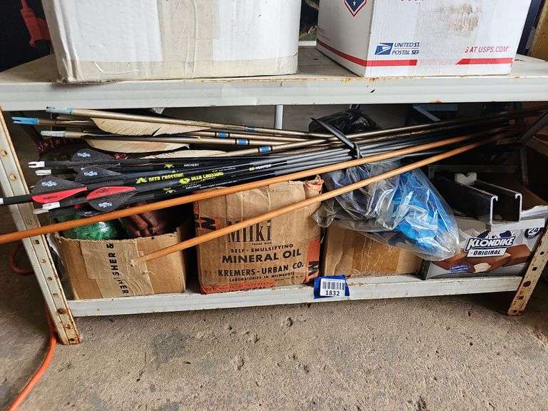 Contents of shelf: archery arrows and supplies
