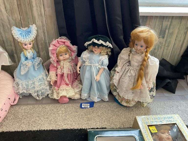 Four porcelain collector dolls