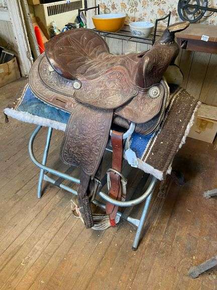 Fancy tooled leather saddle, saddle blanket,  and stand