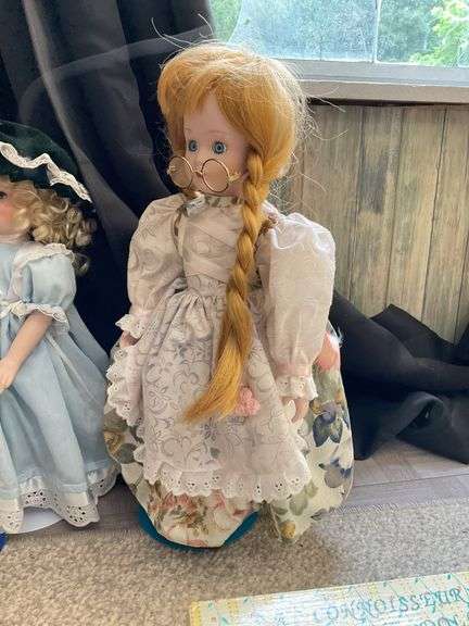 Four porcelain collector dolls
