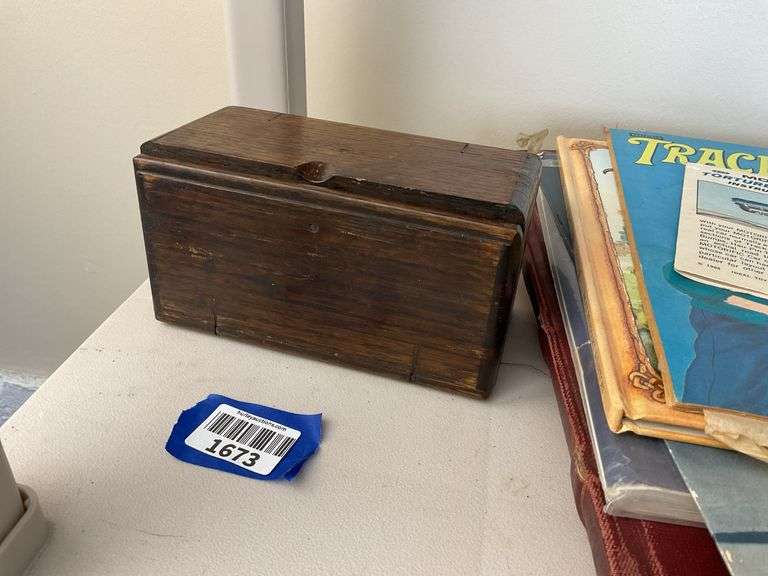 Antique sewing machine attachments in hinged box