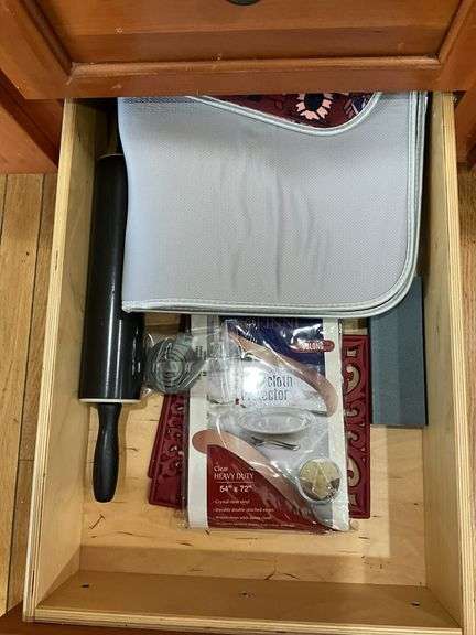 Contents of four drawers and one cupboard: coasters, baking pans, gadgets, hot pads, rolling pin, misc