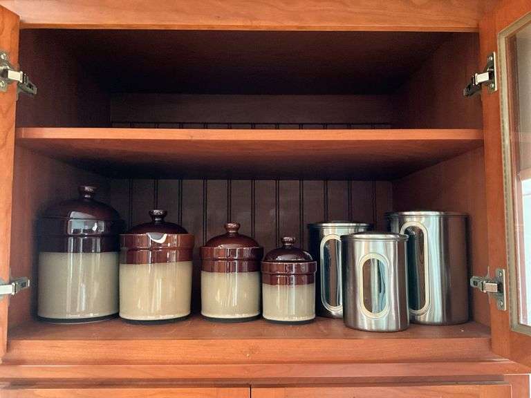 Contents of shelf: 2-tone stoneware canisters, metal canister set