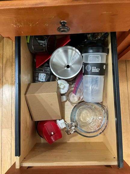 Contents of four drawers: gadgets, household items, measuring cups, power strip, misc