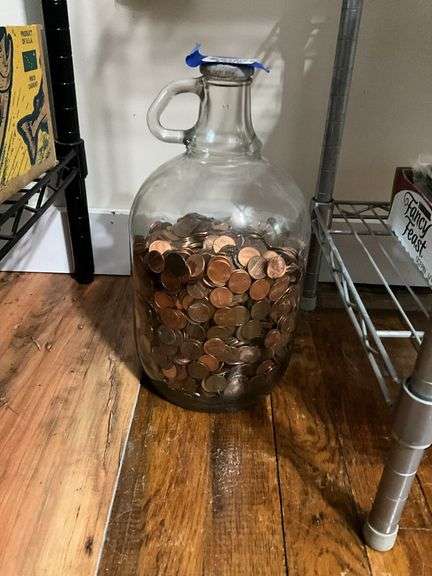 Glass jug of penny coins