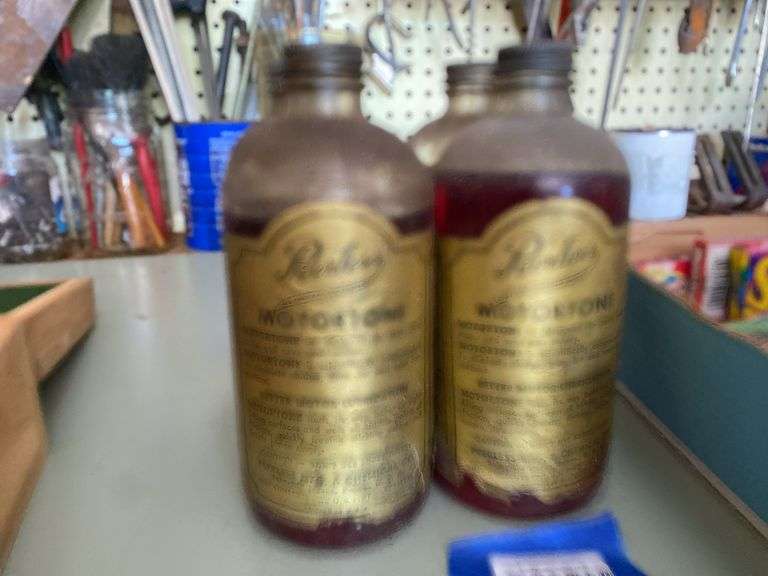 Four Peerless Motortone bottles w/ paper labels