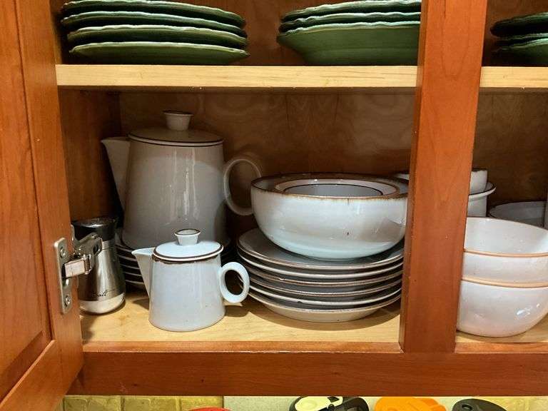 Contents of cupboard: Dansk stoneware dinnerware, green glazed pinecone motif dinnerware