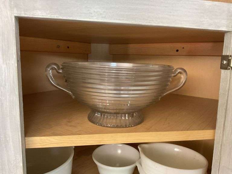 Contents of cupboard: vintage coffee mugs, jadeite glass, milk glass mixer bowls, 2-handle ribbed glass bowl