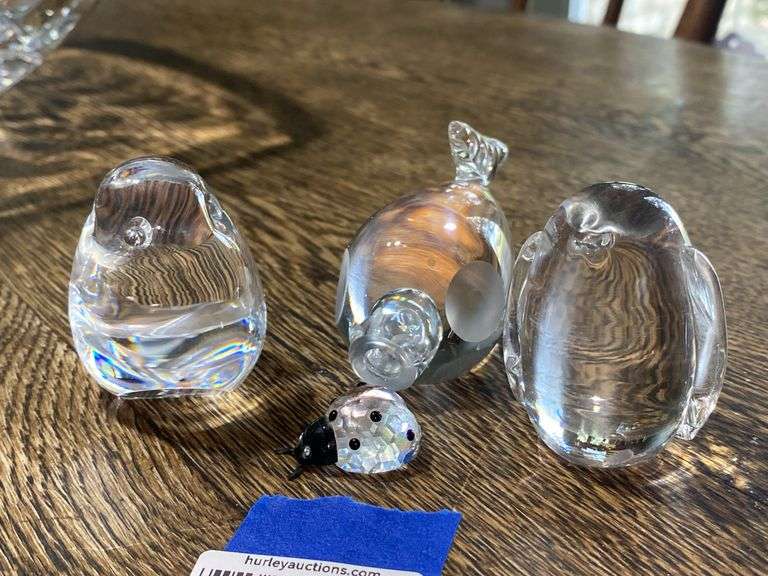 Three glass animal paperweights and Swarovski crystal ladybug