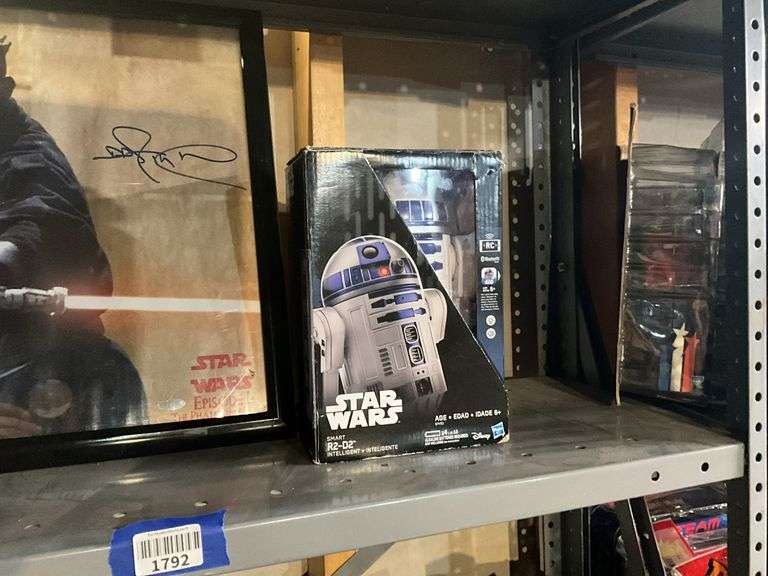 Contents of shelf: RC Star Wars R2D2 toy in box, Ray Park as Darth Maul framed print
