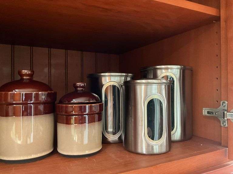Contents of shelf: 2-tone stoneware canisters, metal canister set
