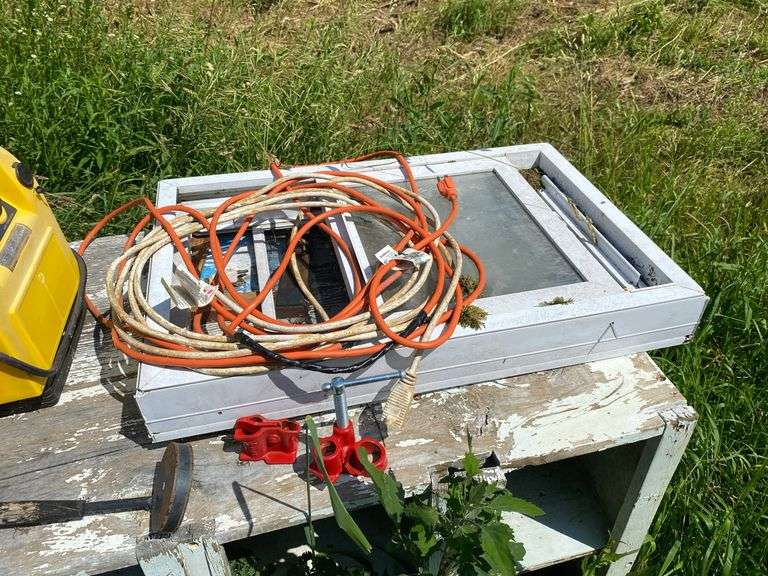 Wooden nesting box and contents: jump started, extension cords, coal bucket, buckets, replacement window, tools, misc