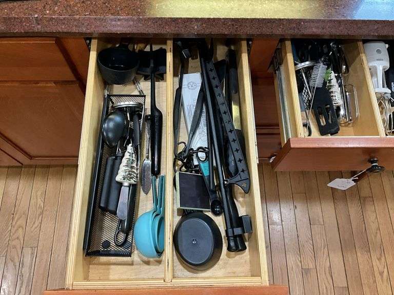 Contents of two drawers: utensils, measuring cups