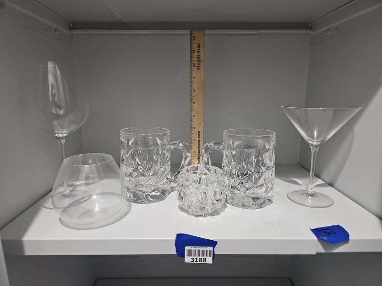 Contents of shelf: Tiffany & Co. rock cut crystal mugs and votive holder, stemware