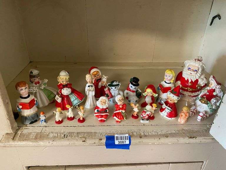 Contents of shelf: vintage china Santa and other Christmas figurines