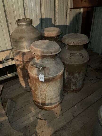 Four milk cans, strainer, *** PLEASE NOTE: This item has no stair access and must be picked up on July 15th between 11:00-1:30PM. Item will be removed from loft for pickup.
