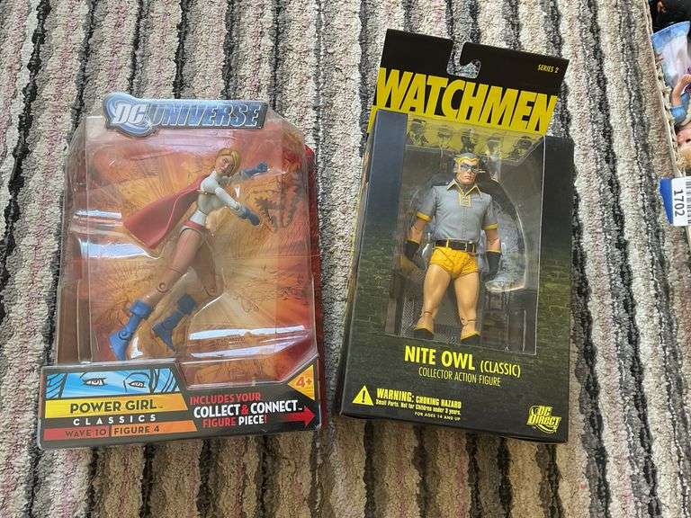 Two action figures in packages: Power Girl and Nite Owl