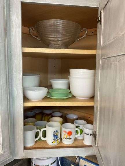 Contents of cupboard: vintage coffee mugs, jadeite glass, milk glass mixer bowls, 2-handle ribbed glass bowl