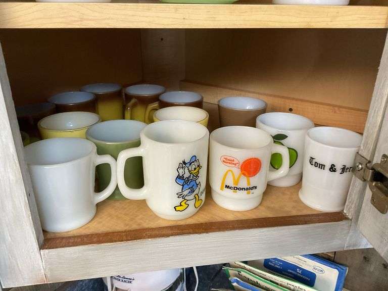 Contents of cupboard: vintage coffee mugs, jadeite glass, milk glass mixer bowls, 2-handle ribbed glass bowl