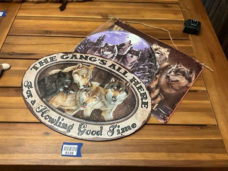 Three metal wolf plaques