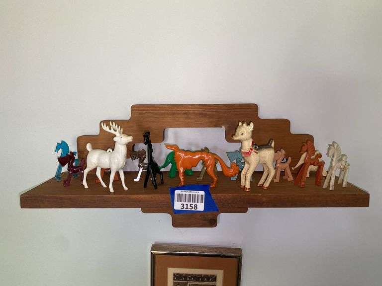 Bracket wall shelf and contents: stylized animal figurines, hard plastic Rudolph and reindeer ornaments