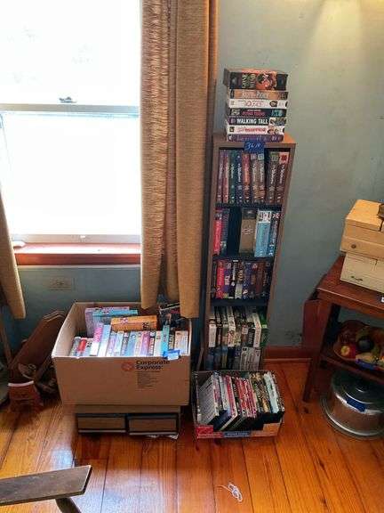 Shelf unit and contents: DVDs, VHS tapes, drawer storage unit