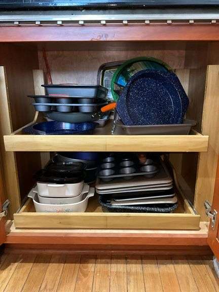 Contents of cupboard: Corningware casseroles, various baking pans, trays