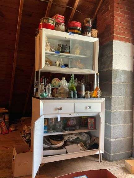 Contents of cabinet: uranium glass basket, cow cookie jar, tins, figurines, figural bottles, ceramic bookends, glassware, kitchenware, misc collectibles
